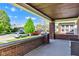 Covered porch featuring brick detailing and neighborhood views, offering a relaxing outdoor space at 1029 E Yoke St, Indianapolis, IN 46203