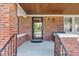Covered porch with brick columns, a clear glass door and stained wood ceiling at 1029 E Yoke St, Indianapolis, IN 46203