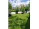 Expansive backyard featuring green space, mature trees, and a charming white picket fence at 1050 Jefferson Ave, Indianapolis, IN 46201