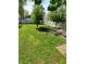 Expansive backyard with lush lawn, mature trees, and garden beds providing a serene outdoor space at 1050 Jefferson Ave, Indianapolis, IN 46201