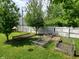 Backyard oasis with garden beds, a fire pit, and a backdrop of lush greenery at 1050 Jefferson Ave, Indianapolis, IN 46201