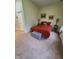 Bedroom with a red bedspread, matching pillows, and bedside tables with lamps at 1050 Jefferson Ave, Indianapolis, IN 46201