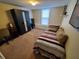 Bedroom with a single bed, wardrobe, carpet, and a window at 1050 Jefferson Ave, Indianapolis, IN 46201