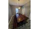 Features a wooden dining table with bench seating, a window, and modern lighting at 1050 Jefferson Ave, Indianapolis, IN 46201