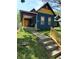 Charming blue home featuring a covered porch with detailed trim and a well-maintained front yard at 1050 Jefferson Ave, Indianapolis, IN 46201