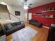 Spacious living room with hardwood floors, bright paint, and a cozy seating arrangement, perfect for entertaining at 1050 Jefferson Ave, Indianapolis, IN 46201