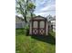 Backyard shed with red trim on a grassy lawn at 1050 Jefferson Ave, Indianapolis, IN 46201
