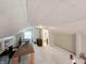 Versatile finished attic space featuring unique design, bright light, and access to additional rooms at 106 Walnut St, Southport, IN 46227