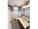 Bathroom with tiled shower, toilet, and vanity with sink; natural light from a window at 106 Walnut St, Southport, IN 46227