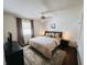 Spacious bedroom featuring neutral tones, a large bed, stylish rug and ceiling fan for added comfort at 106 Walnut St, Southport, IN 46227
