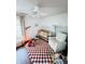 Bright Bedroom with a crib, chair, and playful decor on a bold patterned rug at 106 Walnut St, Southport, IN 46227