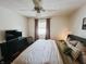 Bright bedroom showcasing a plush bed, television, and window with natural light at 106 Walnut St, Southport, IN 46227
