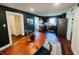 Open dining area features wood table and a view into the kitchen and living spaces at 106 Walnut St, Southport, IN 46227