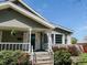 Charming home with a covered front porch and well-maintained landscaping at 106 Walnut St, Southport, IN 46227