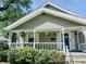 Charming home with a covered front porch and well-maintained landscaping at 106 Walnut St, Southport, IN 46227