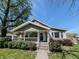 Charming home with a covered front porch and well-maintained landscaping at 106 Walnut St, Southport, IN 46227