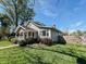 Charming home with a covered front porch and well-maintained landscaping at 106 Walnut St, Southport, IN 46227