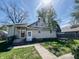 Charming home exterior with a neatly manicured lawn, complemented by a patio set for outdoor enjoyment at 106 Walnut St, Southport, IN 46227