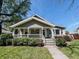 Charming single-story home featuring a cozy front porch and well-maintained landscaping, inviting you to relax and enjoy the outdoors at 106 Walnut St, Southport, IN 46227