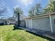 Exterior view of garage features a side door and an overhead door at 106 Walnut St, Southport, IN 46227