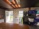 Bright garage interior featuring a workbench, storage shelves, and an open door leading to the outside at 106 Walnut St, Southport, IN 46227