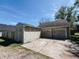 Garage with two doors and siding, with patchy yard in front at 106 Walnut St, Southport, IN 46227