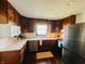Well-lit kitchen featuring wood cabinets, stainless steel appliances, and ample counter space, making meal preparation a delight at 106 Walnut St, Southport, IN 46227