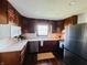 Cozy kitchen featuring wood cabinets, stainless steel appliances, and ample counter space, perfect for cooking and meal preparation at 106 Walnut St, Southport, IN 46227
