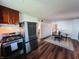 Open concept kitchen with stainless steel fridge and stove, flows into dining area at 106 Walnut St, Southport, IN 46227