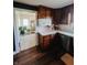 Bright kitchen featuring wood cabinets, stainless steel appliances, and a view to the mudroom, perfect for cooking and storage at 106 Walnut St, Southport, IN 46227