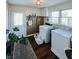 Functional laundry room with washer, dryer, and ample space, enhanced by natural light and decor at 106 Walnut St, Southport, IN 46227