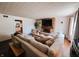 Spacious living room with a large sectional sofa, brick fireplace, and stylish accents, offering plenty of space for entertaining guests at 106 Walnut St, Southport, IN 46227