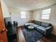 Comfortable living room featuring a modern couch, entertainment center, and stylish decor at 106 Walnut St, Southport, IN 46227