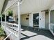 Charming covered front porch with a swing and decorative columns at 106 Walnut St, Southport, IN 46227