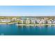Aerial view showcasing homes along the lakefront, each with private docks and boats, set against a serene waterscape at 11484 Lake Stonebridge Ln, Fishers, IN 46037