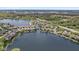 Aerial view of lake houses with private boat docks, and manicured lawns at 11484 Lake Stonebridge Ln, Fishers, IN 46037