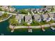 Aerial of lake houses with private docks, boatlifts and lush green lawns on a sunny day at 11484 Lake Stonebridge Ln, Fishers, IN 46037