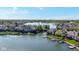 Expansive aerial view of waterfront homes with docks on a tranquil lake in a lush, green community at 11484 Lake Stonebridge Ln, Fishers, IN 46037