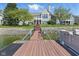 Backyard of waterfront home with stairs leading from the lawn to a private boat dock at 11484 Lake Stonebridge Ln, Fishers, IN 46037