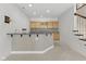 Basement bar area with upper cabinets, sink, and a granite countertop for entertaining at 11484 Lake Stonebridge Ln, Fishers, IN 46037