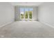 Large bedroom features neutral carpeting, crown molding, and large windows offering views of the lake at 11484 Lake Stonebridge Ln, Fishers, IN 46037