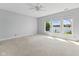 Spacious bedroom with lake views, carpet flooring and ceiling fan at 11484 Lake Stonebridge Ln, Fishers, IN 46037