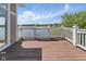 Wooden deck with white railing offers stunning lake views, perfect for relaxing and enjoying the scenery at 11484 Lake Stonebridge Ln, Fishers, IN 46037