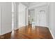 Spacious foyer with gleaming hardwood floors, white columns and trim, and a glimpse of other rooms at 11484 Lake Stonebridge Ln, Fishers, IN 46037