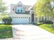 Charming two-story home with a two car garage, mature landscaping, and well maintained lawn at 11484 Lake Stonebridge Ln, Fishers, IN 46037