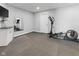 Gym area with full sized mirror, rubberized flooring, and exercise equipment at 11484 Lake Stonebridge Ln, Fishers, IN 46037