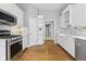 Modern kitchen features white cabinets, stainless steel appliances, and sleek backsplash for a clean aesthetic at 11484 Lake Stonebridge Ln, Fishers, IN 46037