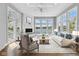 Bright living room featuring a fireplace, hardwood floors, large windows with scenic waterfront views at 11484 Lake Stonebridge Ln, Fishers, IN 46037