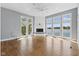 Bright living room featuring a fireplace and an abundance of windows with scenic lake views at 11484 Lake Stonebridge Ln, Fishers, IN 46037