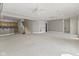 Large open living room area with plush carpeting, stairs, and small breakfast bar area with adjacent kitchen at 11484 Lake Stonebridge Ln, Fishers, IN 46037